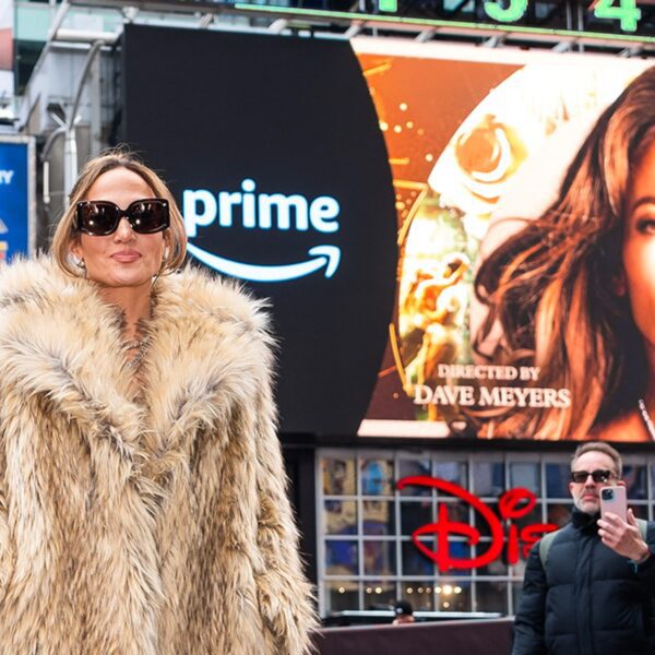 J Lo Poses In Entrance of Occasions Sq. Billboards Selling Her New…