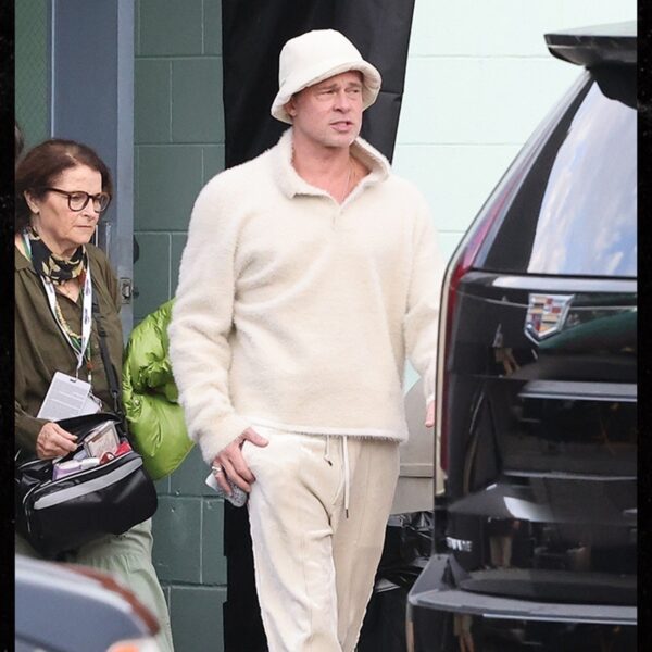 Brad Pitt Flexes Gen-Z Period Look in Bucket Hat, Crocs