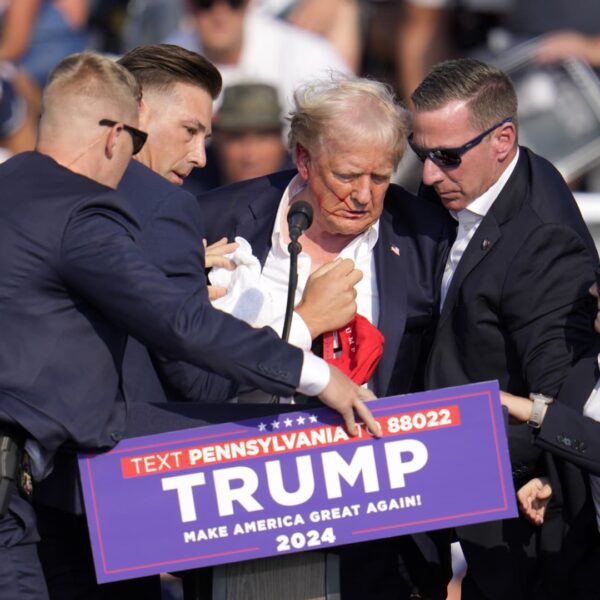 Photos present Trump with blood on his face on stage at rally