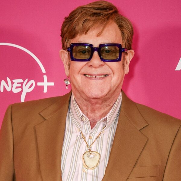 Elton John wears his outdated kneecap as a pendant round his neck…