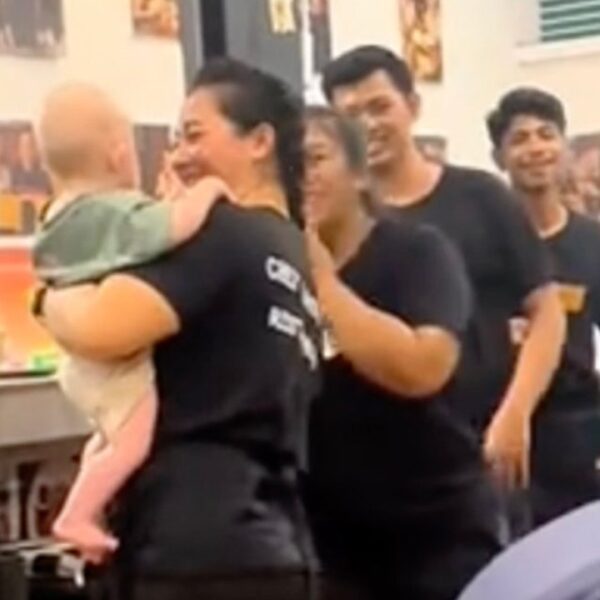 Restaurant employees watch child so dad and mom can eat meals in…