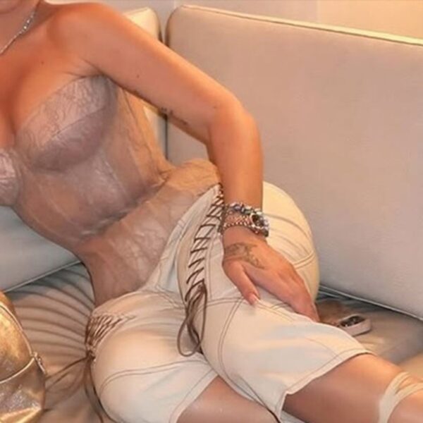 Guess The Sexy Singer Tied Up In This Corset!