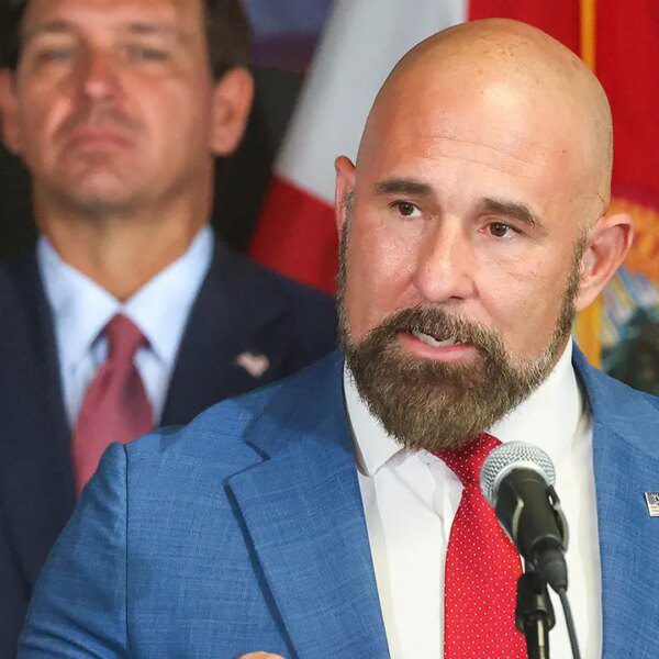 Florida Lt. Gov. Jay Collins seems to take photographs at Rep. Byron…