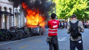 Demonstrators set fireplace to a Tesla, smash home windows at UN workplace throughout anti-G7 protest