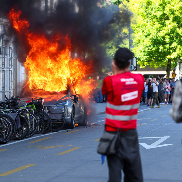 Demonstrators set fireplace to a Tesla, smash home windows at UN workplace&hellip;
