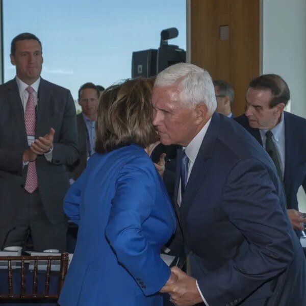 Exclusive: Nancy Pelosi and Mike Pence shared an emotional embrace on the…