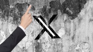X is nudging customers to advertise their posts with a pointing hand, and individuals are confused